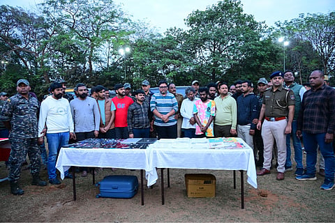 The members of the gang posing with the police after being arrested 