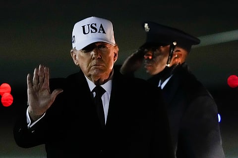 President Donald Trump waves after arriving on Air Force One from Florida, Sunday, Jan. 11, 2026.