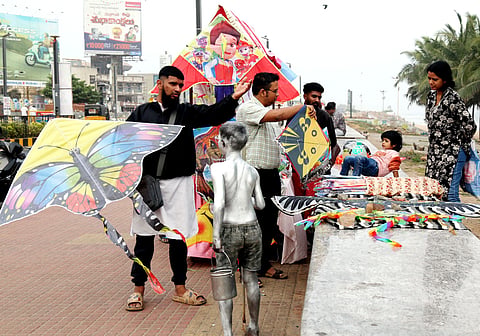 People buy kites  on the Beach Road in Vizag on Monday.