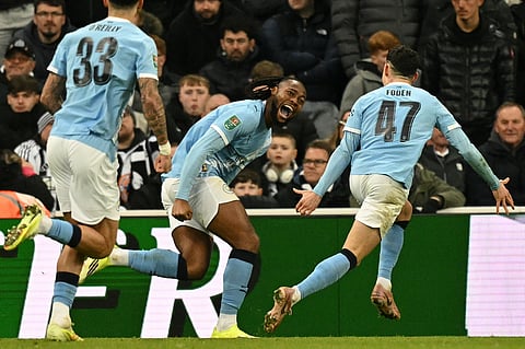 Manchester City's Antoine Semenyo (C) celebrates with teammates after scoring the opening goal of the English League Cup semi-final first leg football match between Newcastle United and Manchester City on January 13, 2026. 