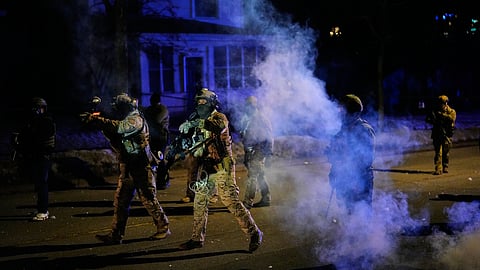 Federal immigration officers shoot pepper balls as tear gas is deployed at the scene of a reported shooting Wednesday, Jan. 14, 2026, in Minneapolis.