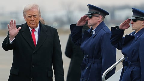 President Donald Trump waves during his arrival at Detroit Metropolitan Wayne County Airport, Tuesday, Jan. 13, 2026, in Detroit. 