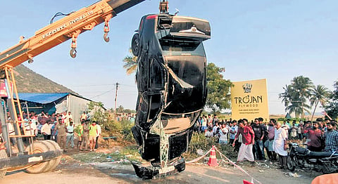 Fire and rescue personnel retrieving the car from the roadside well. 