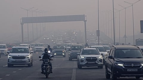 Commuters make their way during a cold and foggy winter morning, in New Delhi, Monday, Jan. 19, 2026.