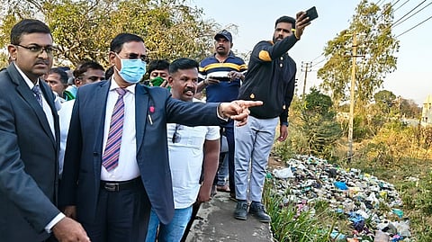 Upa Lokayukta Justice B Veerappa along with Aravind N V, Deputy Registrar-1, inspecting lakes in Doddaballapura on Tuesday. 