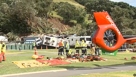 In this image from a video, a police officer with dog searches people near the site of a landslide at the base of Mount Maunganui on New Zealand’s North Island Thursday, Jan. 22, 2026. 