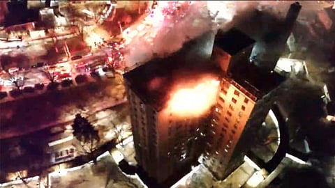 This image provided by FDNY shows FDNY members operating at a fire on the top two floors of a high-rise apartment in the Bronx, New York City, early Saturday, Jan. 24, 2026.