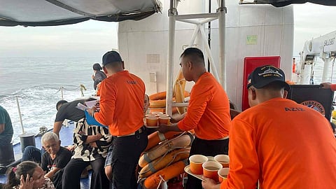 This photo released by the Philippine Coast Guard shows its personnel tending to people who were aboard the M/V Trisha Kerstin 3 around the waters of Baluk-Baluk Island, Basilan, Philippines Monday, Jan. 26, 2026. 