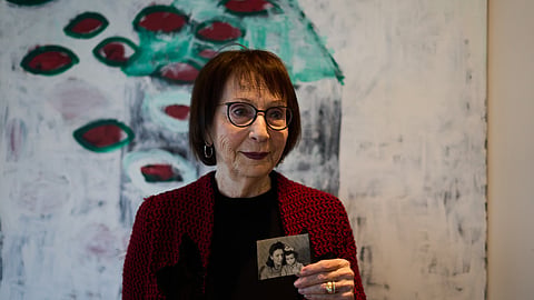 Holocaust survivor Ilana Shalem-Kantorowics, born in the Nazi Bergen-Belsen concentration camp, holds a photo of her with her mother Lola taken in the camp in 1946, in Tel Aviv, Israel, Jan. 26, 2026. 