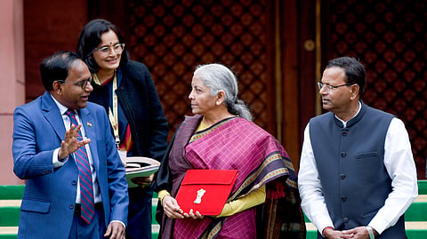 Union Finance Minister Nirmala Sitharaman shows the Budget tablet as she arrives at the Parliament House to present the Union Budget 2026, in New Delhi on Sunday. Union Minister of State for Finance Pankaj Chaudhary also present. 