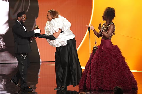 Kendrick Lamar, left, accepts the award for best rap album for "GNX" from Queen Latifah, and Doechii during the 68th annual Grammy Awards on Sunday, Feb. 1, 2026, in Los Angeles.