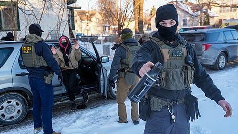 Activists are approached by federal agents for following agent vehicles, on Tuesday, Feb. 3, 2026, in Minneapolis.