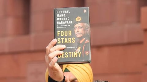Leader of Opposition in the Lok Sabha Rahul Gandhi shows a copy of the unpublished memoir of ormer Army chief General Manoj Mukund Naravane's during Budget Session of Parliament.