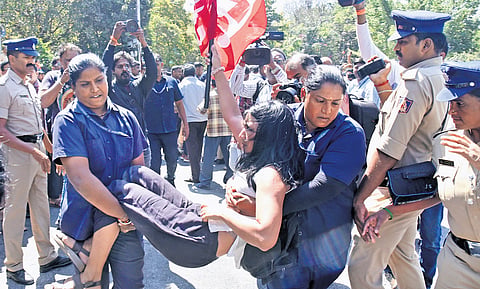 Police detain a protestor in front of Town Hall on Thursday 