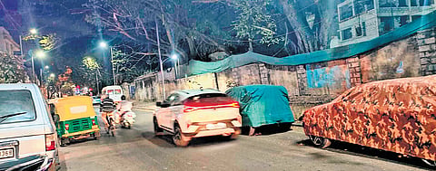 Vehicles parked along Kamaraj Road after No Parking boards were removed 