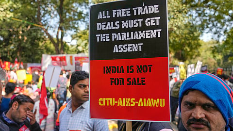 Members of trade unions hold banners during a nationwide strike to protest an interim trade deal with the United States, saying the agreement undermines the interests of farmers, small businesses and workers in New Delhi, India, Thursday, Feb. 12, 2026. 