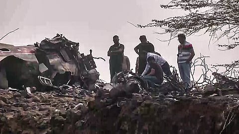 A team of forensic experts investigates the site of the plane crash,