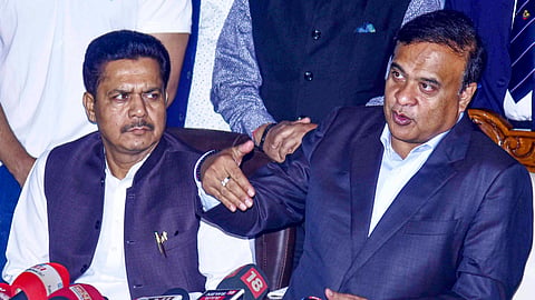 Assam Chief Minister Himanta Biswa Sarma with former state Congress president Bhupen Borah during a press conference, in Guwahati, Tuesday, Feb. 17, 2026. 