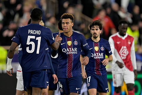 PSG players celebrate at the end of the first-leg of the Champions League playoff soccer match between Monaco and Paris Saint-Germain in Monaco, Tuesday, Feb. 17, 2026. 