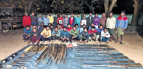 The arrested poachers posing with their firearms and weapons 