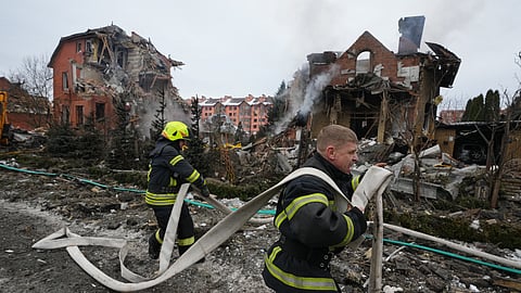 Firefighters put out a fire after a drone hit a residential building during a Russian air attack in Kyiv, Ukraine, Sunday, Feb. 22, 2026.
