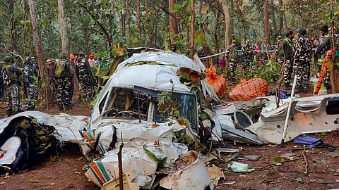 Security officials and locals gather near the wreckage of a Redbird Airways Pvt Ltd Beechcraft C90 air ambulance that crashed near Simaria, in Chatra district, Jharkhand, Tuesday, Feb. 24, 2026. 