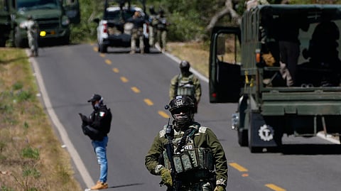 A soldier clears a roadblock on a road leading to Tapalpa, Mexico, Monday, Feb. 23, 2026, a day after the Mexican army killed Jalisco New Generation Cartel leader Nemesio Oseguera Cervantes, known as "El Mencho." 
