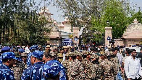 Security personnel stand guard outside Patiala House Court as Indian Youth Congress (IYC) national president Uday Bhanu Chib is produced before the court following his arrest in connection with a protest at the AI Impact Summit, in New Delhi, Tuesday, Feb. 24, 2026. 