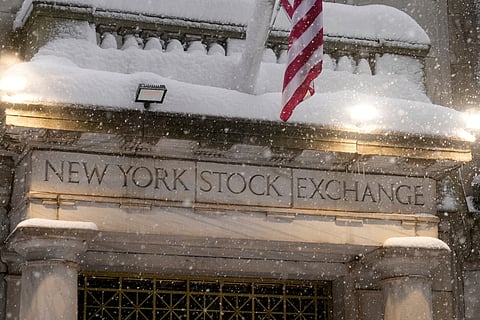 Snow falls outside the New York Stock Exchange, Monday, Feb. 23, 2026, in New York. 