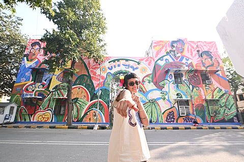 Artist Jumu in front of her mural  ‘Magical' in Lodhi Art District