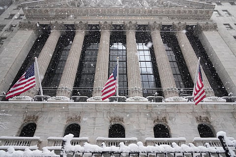 Snow falls outside the New York Stock Exchange, Monday, Feb. 23, 2026, in New York. 