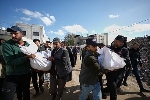Mourners carry the bodies of two members of Hamas, Muhammad Abu Jabal, and Fadl Al-Burdini who were killed in an Israeli military strike, at Shifa Hospital in Gaza City Thursday, Feb. 26, 2026. 