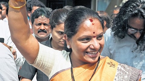Former MLC K Kavitha pumps her fist in the air as she celebrates the court verdict 