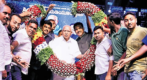Former CM BS Yediyurappa being felicitated by his fans in Shikarupura on Friday. 
His sons BY Raghavendra and BY Vijayendra look on  