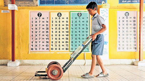 M Muhammad Asif using the solar-powered cleaning tool he created after noticing his mom at home and women working in school exert too much to clean the floors 