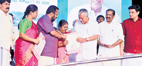 Vellarmala native Madhavi breaks down while receiving the title deed from Chief Minister Pinarayi Vijayan at the Kalpetta Township Project inauguration in Wayanad 