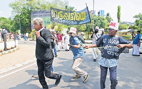 Activists of the Purogamana Kala Sahithya Sangam staging a street play in Kochi against 
US-Israel strikes on Iran and killing of Iranian leader Ayatollah Ali Khamenei 
