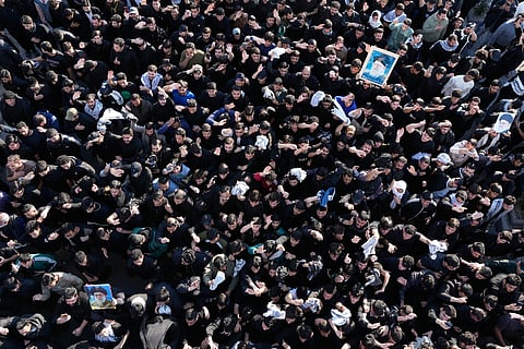Iraqi Shiites hold pictures of Iranian supreme Leader Ayatollah Ali Khamenei, who was killed by a U.S. airstrike in Tehran, during a symbolic funeral of Sadr City, Baghdad, Iraq, Sunday, March 1, 2026. 