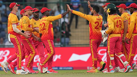 Zimbabwe's captain Sikandar Raza, centre, celebrates with teammates the wicket of South Africa's Dewald Brevis during the T20 World Cup cricket match between South Africa and Zimbabwe in New Delhi, India, Sunday, March 1, 2026. 
