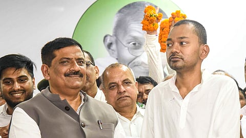 JD(U) National Working President Sanjay Jha, left, presents membership slip to Bihar Chief Minister Nitish Kumar's son Nishant Kumar as he joins the party, in Patna, Bihar, Sunday, March 8, 2026. 