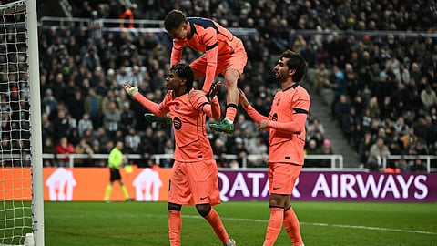 Barcelona's Lamine Yamal (L) celebrates scoring the team's first goal during the UEFA Champion's League, round of 16 football match between Newcastle United and FC Barcelona on March 10, 2026. 
