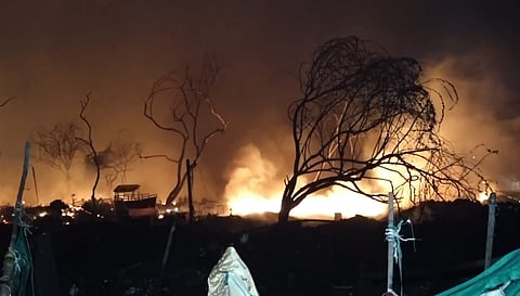 Flames and smoke billow from a blaze near a fish market, in Matiala village, Uttam Nagar, New Delhi, late Wednesday, March 11, 2026. 