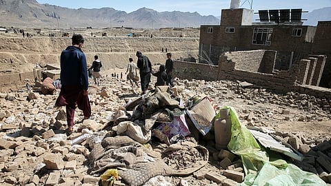 Residents inspect the site of a Pakistani strike in Kabul, Afghanistan, Friday, March 13, 2026.