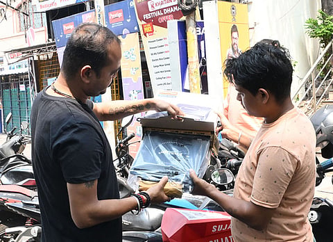 A dealer unboxes the electric induction stoves to put them on sale, while the demand has gone up due to the restricted supply of domestic LPG Cylinder