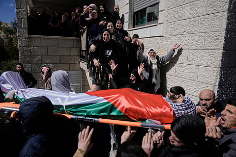 Palestinians carry the body of Thaer Farouq Hamayel, 24, who was killed in a violent clash with Israeli settlers, during his funeral in the West Bank village of Abu Falah, Sunday, March 8, 2026. 
