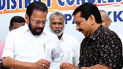 A Suresh receiving Congress membership from Palakkad DCC president  A Thankappan on Tuesday