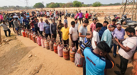 In this image from March 13, 2026, people are seen queuing up with their empty cylinders outside an LPG depot to receive refilled ones, amid supply crisis in the country, in Bhubaneswar, Odisha. 