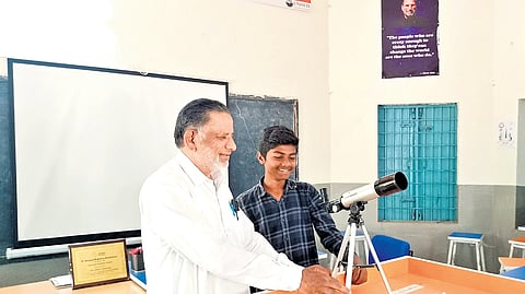 Md Javed, a Hindi teacher at the Government High School in Savaran, explains 
the working principle of a telescope to his student, Syed Hanif.