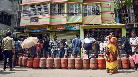 People wait in a queue outside a gas agency in Kolkata to refill the LPG cylinders amid reports of a nationwide shortage of LPG. 