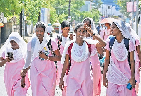 Nursing students protect themselves from day to day increasing heat in Tiruchy on Monday 